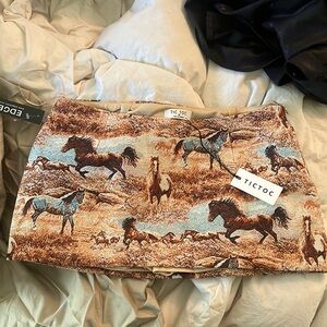 Cute textured skirt with horses western style .